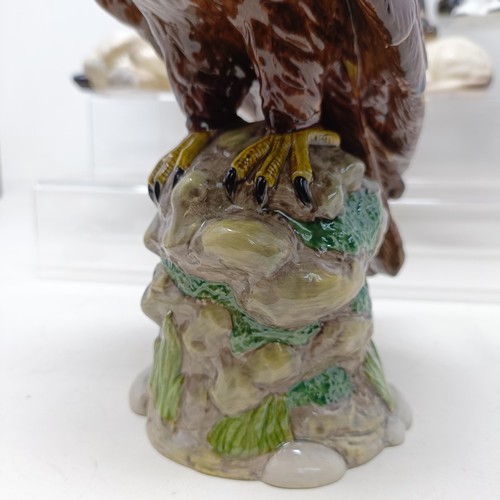 724 - A Royal Doulton figure of a Golden Eagle, RDA36, Buddies HN2546, a figure of a reclining dog, and as... 