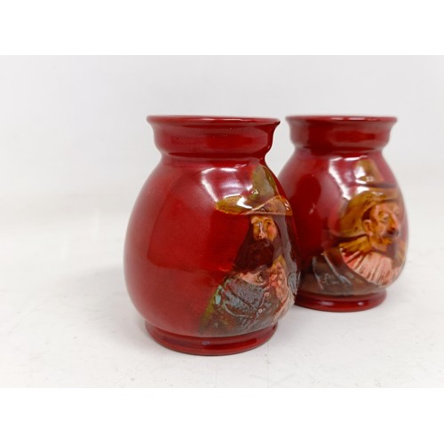 739 - A pair of Royal Doulton squat vases, by Charles Noke, decorated figures, 9 cm high (2)