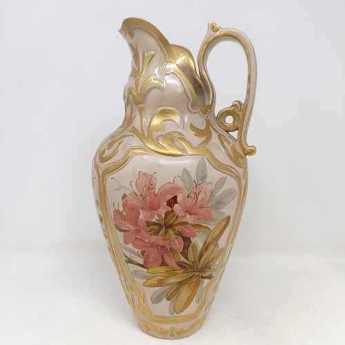 743 - A Doulton Lambeth ewer, by Frank A Butler, decorated with flowers, highlighted in gilt, 30 cm high