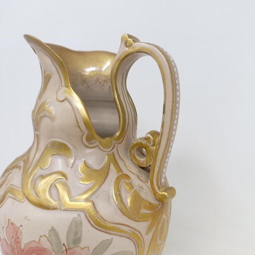 743 - A Doulton Lambeth ewer, by Frank A Butler, decorated with flowers, highlighted in gilt, 30 cm high