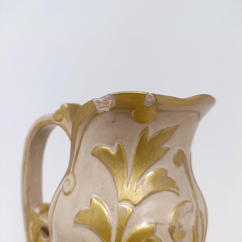 743 - A Doulton Lambeth ewer, by Frank A Butler, decorated with flowers, highlighted in gilt, 30 cm high