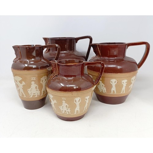 744 - A graduated set of Doulton Lambeth jugs, 20 cm, 18 cm and 14 cm, and another similar, 18 cm (4)