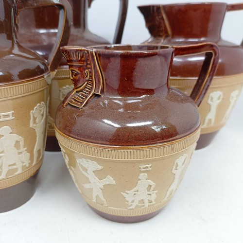 744 - A graduated set of Doulton Lambeth jugs, 20 cm, 18 cm and 14 cm, and another similar, 18 cm (4)