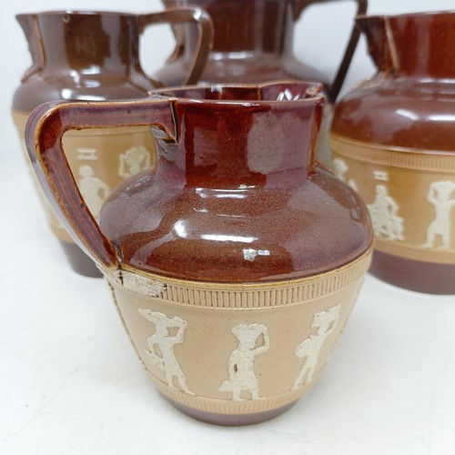 744 - A graduated set of Doulton Lambeth jugs, 20 cm, 18 cm and 14 cm, and another similar, 18 cm (4)