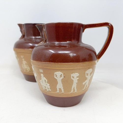 744 - A graduated set of Doulton Lambeth jugs, 20 cm, 18 cm and 14 cm, and another similar, 18 cm (4)