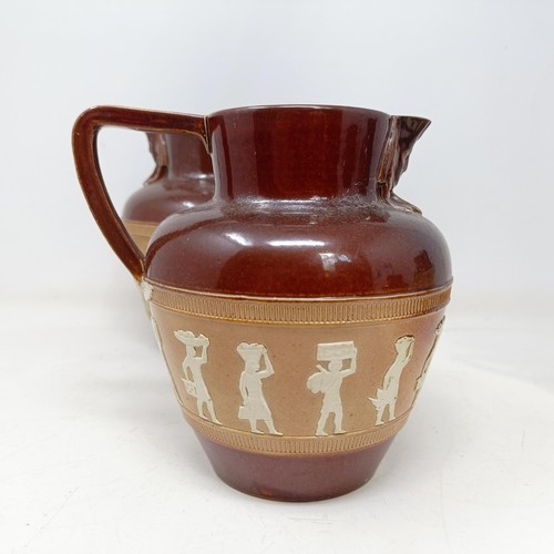 744 - A graduated set of Doulton Lambeth jugs, 20 cm, 18 cm and 14 cm, and another similar, 18 cm (4)