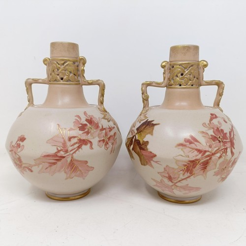 765 - A pair of Doulton Lambeth blush ivory twin handle vases, decorated flowers, highlighted in gilt, 17 ... 