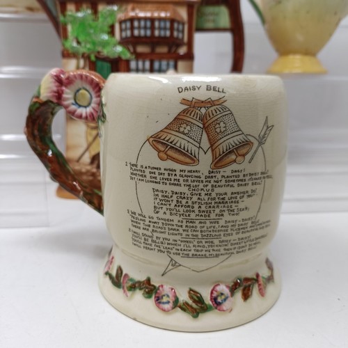 767 - A Royal Doulton Dickens Ware musical jug, The Gaffers Story, 20 cm high, a coffee pot, decorated lan... 