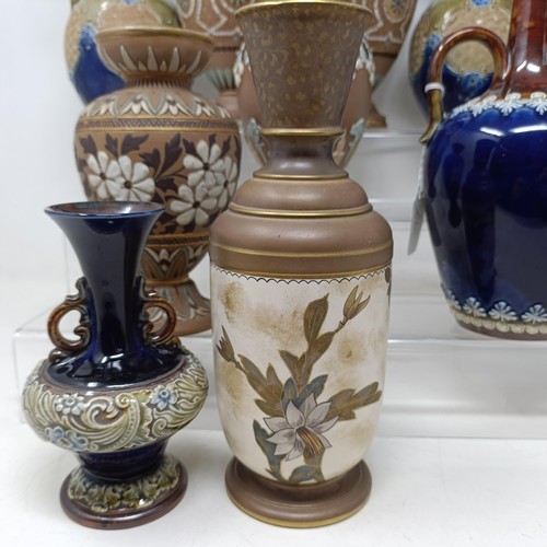 768 - A Doulton vase, decorated flowers, 23 cm high, a Doulton Lambeth spirit flask, by Bessie Newberry, l... 