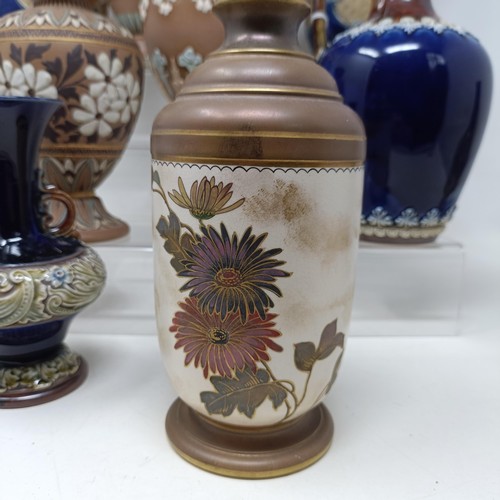 768 - A Doulton vase, decorated flowers, 23 cm high, a Doulton Lambeth spirit flask, by Bessie Newberry, l... 