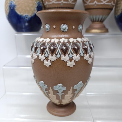 768 - A Doulton vase, decorated flowers, 23 cm high, a Doulton Lambeth spirit flask, by Bessie Newberry, l... 