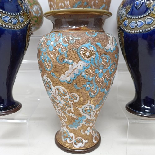 771 - A pair of Royal Doulton ewers, 29 cm high, a Royal Doulton vase, 24 cm high, a pair of Royal Doulton... 