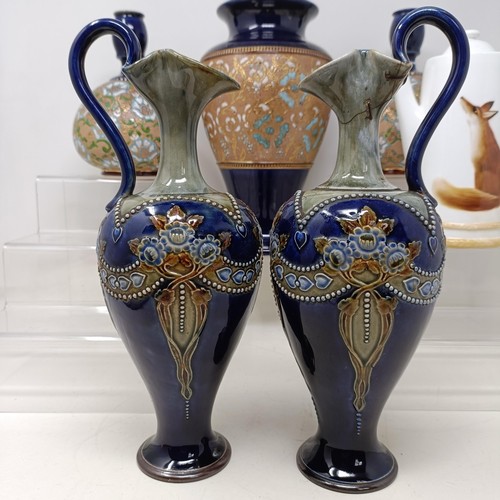 771 - A pair of Royal Doulton ewers, 29 cm high, a Royal Doulton vase, 24 cm high, a pair of Royal Doulton... 