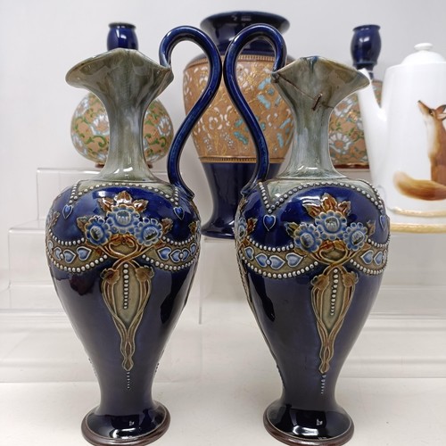 771 - A pair of Royal Doulton ewers, 29 cm high, a Royal Doulton vase, 24 cm high, a pair of Royal Doulton... 