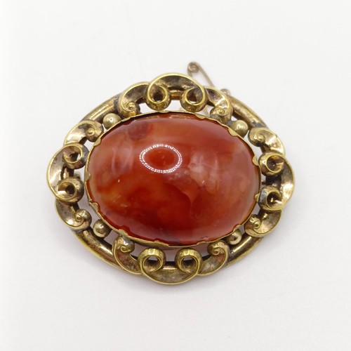 889 - An early 20th century yellow coloured metal and amber coloured stone brooch, a yellow metal and blue... 