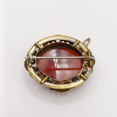 889 - An early 20th century yellow coloured metal and amber coloured stone brooch, a yellow metal and blue... 