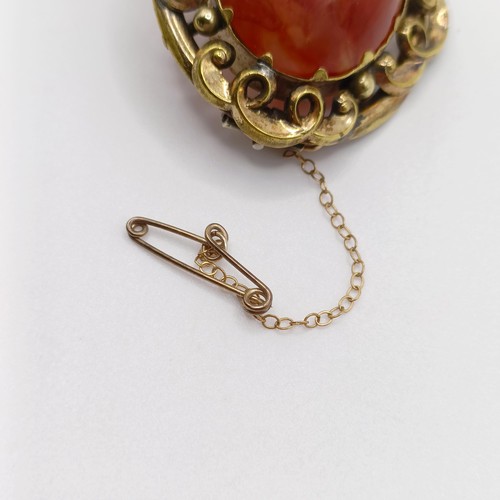 889 - An early 20th century yellow coloured metal and amber coloured stone brooch, a yellow metal and blue... 