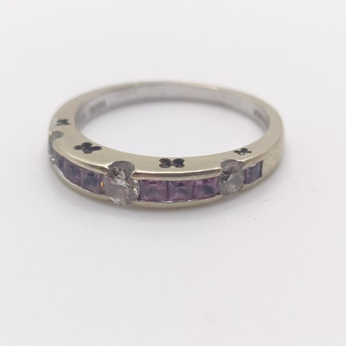 887 - An 18ct white gold, diamond and pink stone half eternity ring, ring size L