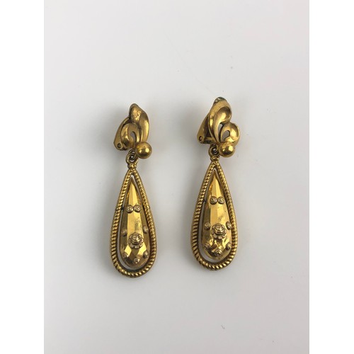 885 - A pair of Indian yellow coloured metal tear drop earrings