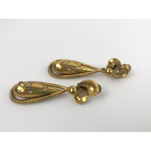 885 - A pair of Indian yellow coloured metal tear drop earrings