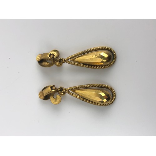 885 - A pair of Indian yellow coloured metal tear drop earrings