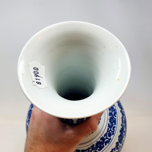 835 - A Chinese blue and white bottle vase, decorated lotus flowers in underglaze blue, 38 cm high