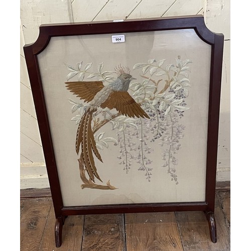 878 - A silk embroidered panel, decorated exotic birds, inset in a firescreen with a mahogany frame, 72 x ... 