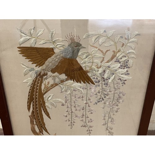 878 - A silk embroidered panel, decorated exotic birds, inset in a firescreen with a mahogany frame, 72 x ... 