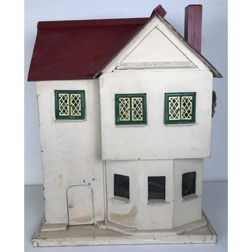 328 - A mid 20th century painted dolls house, with assorted furniture, 56 cm wide, a childs cot, toys, and... 