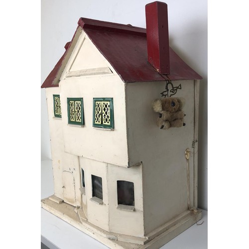 328 - A mid 20th century painted dolls house, with assorted furniture, 56 cm wide, a childs cot, toys, and... 