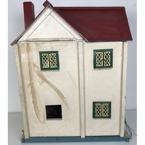 328 - A mid 20th century painted dolls house, with assorted furniture, 56 cm wide, a childs cot, toys, and... 