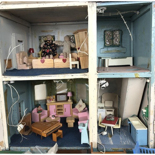 328 - A mid 20th century painted dolls house, with assorted furniture, 56 cm wide, a childs cot, toys, and... 