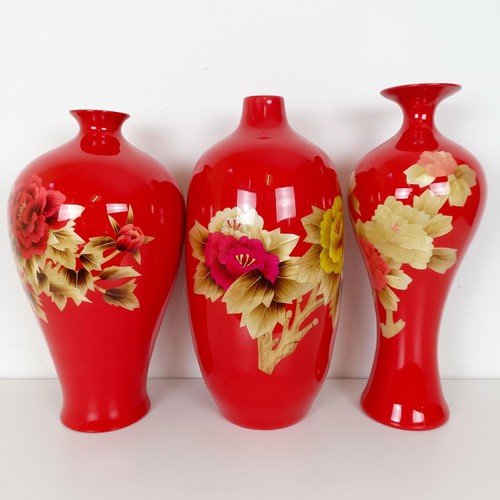 810 - A Japanese red ground vase, decorated flowers, 46 cm high, another similar, 48 cm high and another s... 