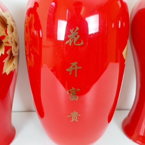 810 - A Japanese red ground vase, decorated flowers, 46 cm high, another similar, 48 cm high and another s... 