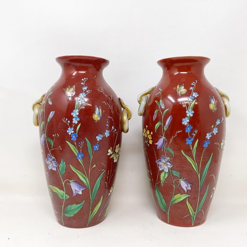 819 - A pair of late 19th century opaque glass vases, with over enamel decoration, decorated flowers and b... 