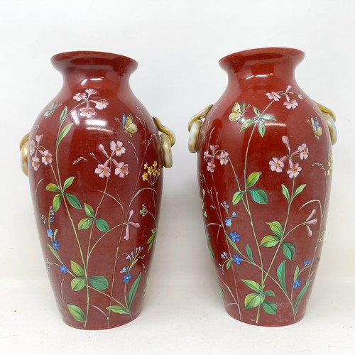 819 - A pair of late 19th century opaque glass vases, with over enamel decoration, decorated flowers and b... 