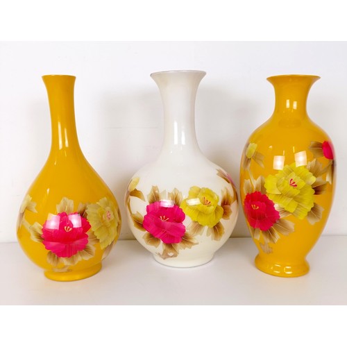 825 - A Japanese yellow ground vase, decorated flowers, 38 cm high, another similar 36 cm high, and a simi... 