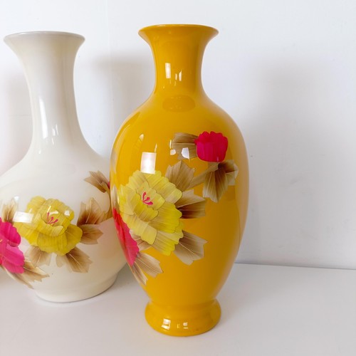 825 - A Japanese yellow ground vase, decorated flowers, 38 cm high, another similar 36 cm high, and a simi... 