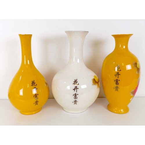 825 - A Japanese yellow ground vase, decorated flowers, 38 cm high, another similar 36 cm high, and a simi... 