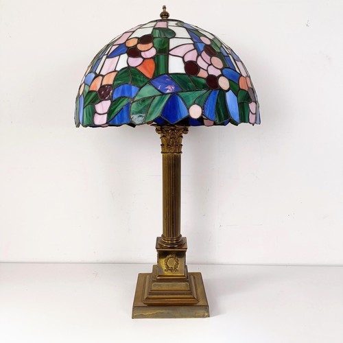 831 - A Tiffany style lamp, on a brass base, in the form of a Corinthian column, 73 cm high