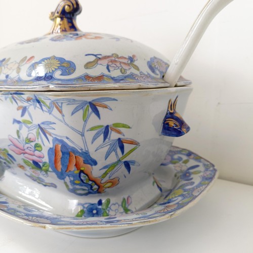 832 - A Masons ironstone tureen and cover, on a stand with a ladle, 43 cm wide, and a lamp base, decorated... 