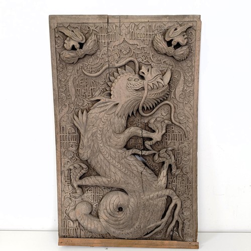 837 - An Indo-Chinese carved wooden plaque, decorated a dragon, 65 x 43 cm