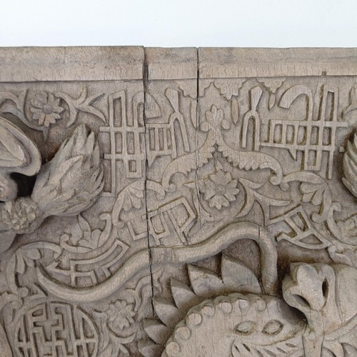 837 - An Indo-Chinese carved wooden plaque, decorated a dragon, 65 x 43 cm