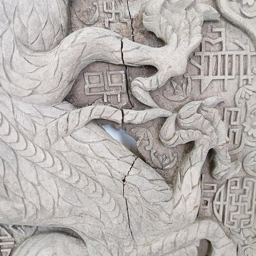 837 - An Indo-Chinese carved wooden plaque, decorated a dragon, 65 x 43 cm