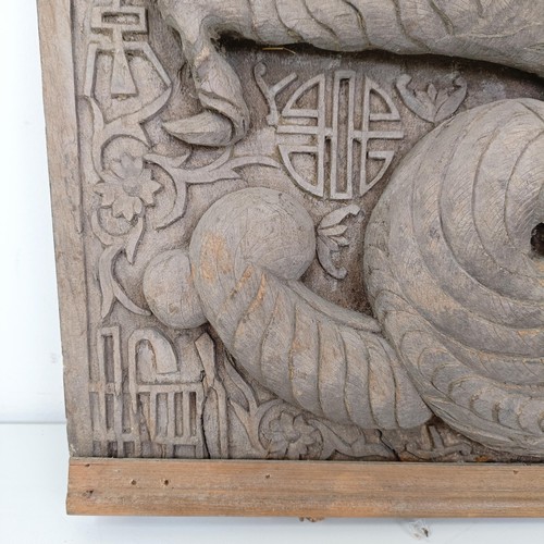 837 - An Indo-Chinese carved wooden plaque, decorated a dragon, 65 x 43 cm