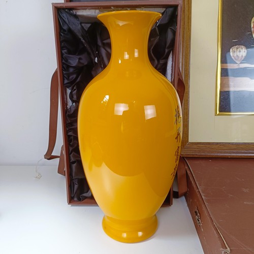 838 - A Japanese yellow vase decorated with flowers, boxed, and a straw picture of hot air balloons, cased... 