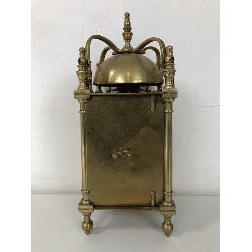 873 - A lantern clock, in a brass case, 20 cm high