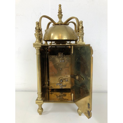 873 - A lantern clock, in a brass case, 20 cm high