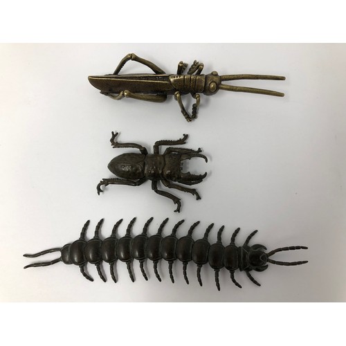 869 - A Japanese figure of a cricket, 12 cm wide, a stag beetle, 6 cm wide, and a millipede, 16 cm wide (3... 