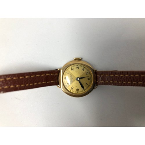 866 - A yellow coloured metal ladies wristwatch, on a leather strap, another, and assorted costume jewelle... 